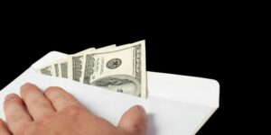 Bribe in an envelope and hand