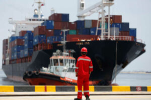 A port worker watches as a ship leaves the New Priok Container Terminal 1 in North Jakarta